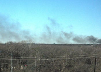 Firefighters tackling RV and shed fire in wooded area in east Austin