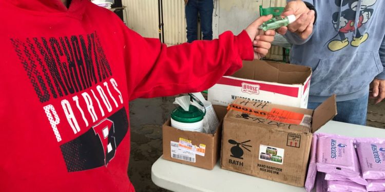 Volunteers hand out supplies to help homeless fight coronavirus outbreak